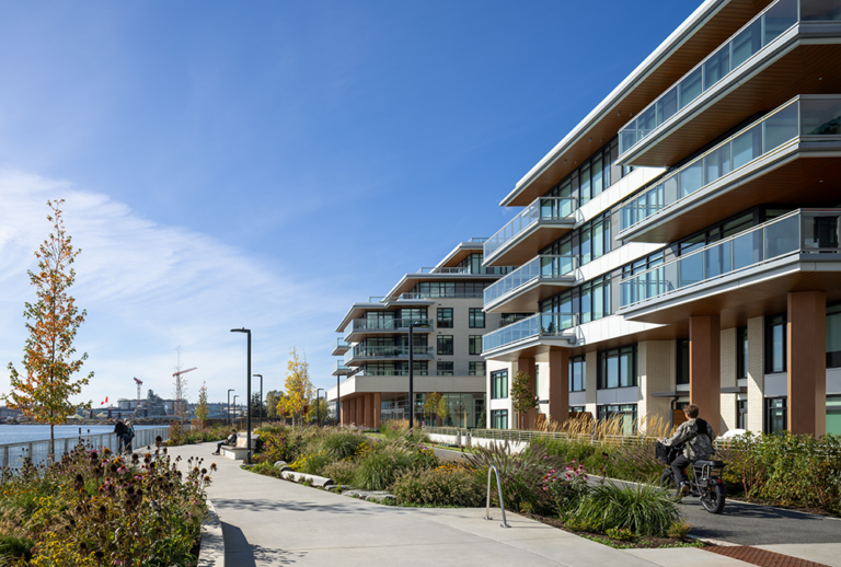 The completed Aire West and Aire East, with landscaped bike and pedestrian paths between the buildings and the waterfront.