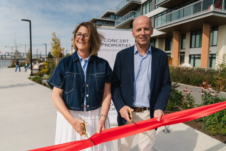 Mayor Linda Buchanan and Concert COO Craig Watters cutting a red ribbon in front of North Harbour, by the waterfront.